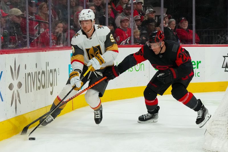 Mar 11, 2023; Raleigh, North Carolina, USA;  Vegas Golden Knights center Jack Eichel (9) skates with the puck past Carolina Hurricanes center Paul Stastny (26) during the second period at PNC Arena. Mandatory Credit: James Guillory-USA TODAY Sports