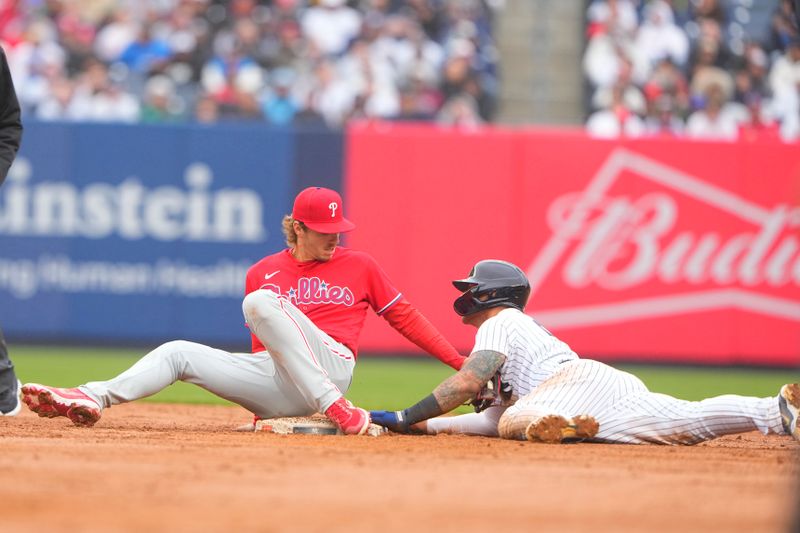 Apr 5, 2023; Bronx, New York, USA;  New York Yankees designated hitter Gleybor Torres (25) steals second base ahead of the tag by Philadelphia Phillies second baseman Bryson Stott (5) during the sixth inning at Yankee Stadium. Mandatory Credit: Gregory Fisher-USA TODAY Sports