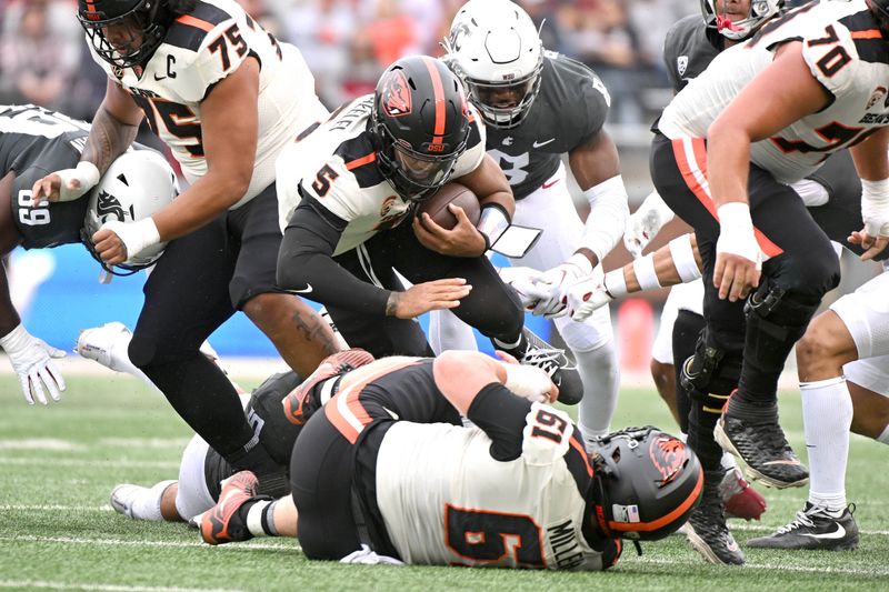 Sep 23, 2023; Pullman, Washington, USA; Oregon State Beavers quarterback DJ Uiagalelei (5) runs for a first down against the Washington State Cougars in the first half at Gesa Field at Martin Stadium. Mandatory Credit: James Snook-USA TODAY Sports