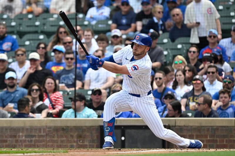 May 4, 2024; Chicago, Illinois, USA;  Chicago Cubs first base Michael Busch (29) hits an RBI single against the Milwaukee Brewers during the first inning at Wrigley Field. Mandatory Credit: Matt Marton-USA TODAY Sports