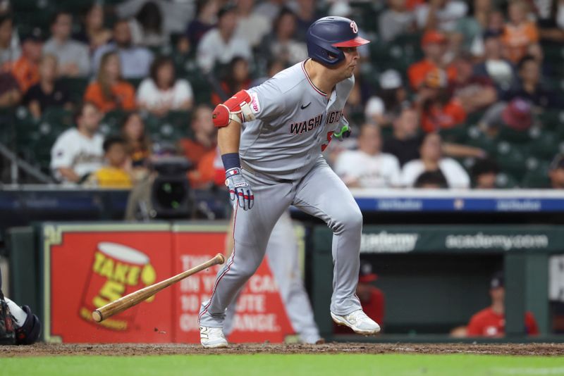 Jul 29, 2025; Houston, Texas, USA; Washington Nationals first baseman Nathaniel Lowe (33) hits a single during the eighth inning against the Houston Astros at Daikin Park. Mandatory Credit: Troy Taormina-Imagn Images