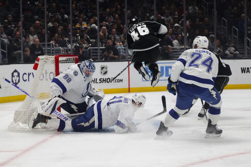 Mar 23, 2024; Los Angeles, California, USA; Los Angeles Kings center Blake Lizotte (46) leaps over Tampa Bay Lighting defensemen Erik Cernak (81) during the second period of an NHL hockey game at Crypto.com Arena. Mandatory Credit: Yannick Peterhans-USA TODAY Sports