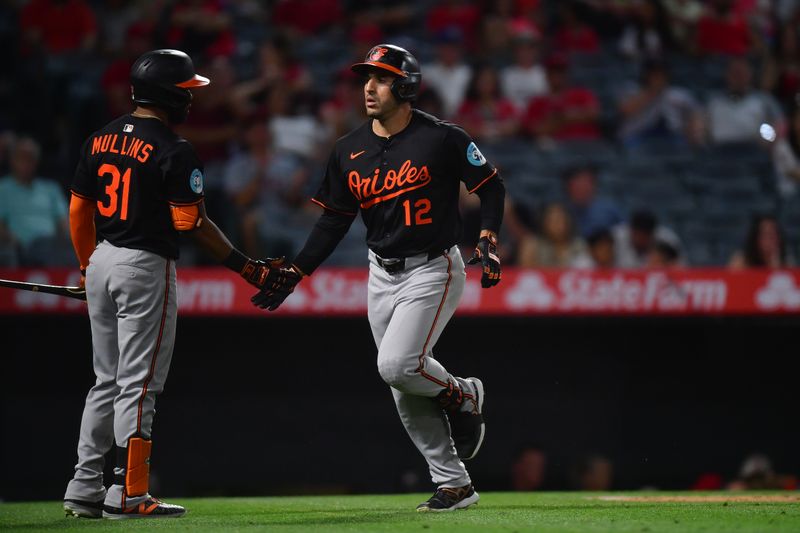 May 10, 2025; Anaheim, California, USA; Baltimore Orioles outfielder Ramon Laureano (12) is greeted by center fielder Cedric Mullins (31) after hitting a solo home run against the Los Angeles Angels during the ninth inning at Angel Stadium. Mandatory Credit: Gary A. Vasquez-Imagn Images