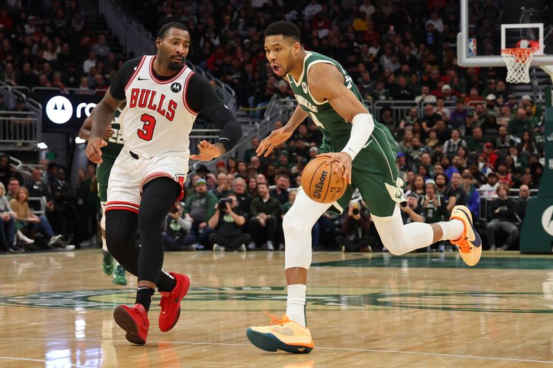 MILWAUKEE, WISCONSIN - DECEMBER 11: Giannis Antetokounmpo #34 of the Milwaukee Bucks drives to the basket against Andre Drummond #3 of the Chicago Bulls during a game at Fiserv Forum on December 11, 2023 in Milwaukee, Wisconsin. NOTE TO USER: User expressly acknowledges and agrees that, by downloading and or using this photograph, User is consenting to the terms and conditions of the Getty Images License Agreement. (Photo by Stacy Revere/Getty Images)