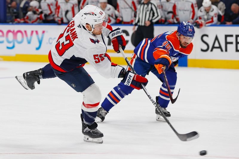 Jan 24, 2026; Edmonton, Alberta, CAN; Washington Capitals forward Ethen Frank (53) takes a shot in front of Edmonton Oilers defensemen Jake Wahlman (96) during the second period at Rogers Place. Mandatory Credit: Perry Nelson-Imagn Images