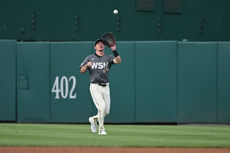 Aug 3, 2024; Washington, District of Columbia, USA; Washington Nationals center fielder Jacob Young (30) makes a catches a pop up in the outfield against the Milwaukee Brewers during the first inning at Nationals Park. Mandatory Credit: Rafael Suanes-USA TODAY Sports