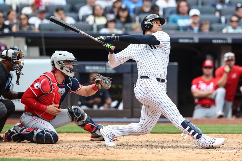 Jul 4, 2024; Bronx, New York, USA; New York Yankees right fielder Juan Soto (22) hits a two run home run in the seventh inning against the Cincinnati Reds at Yankee Stadium. Mandatory Credit: Wendell Cruz-USA TODAY Sports