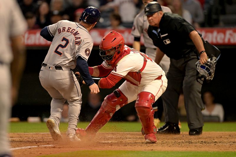 Jun 8, 2024; Anaheim, California, USA;  Houston Astros third baseman Alex Bregman (2) is tagged out at home by Los Angeles Angels catcher Matt Thaiss (21) in the third inning at Angel Stadium. Mandatory Credit: Jayne Kamin-Oncea-USA TODAY Sports