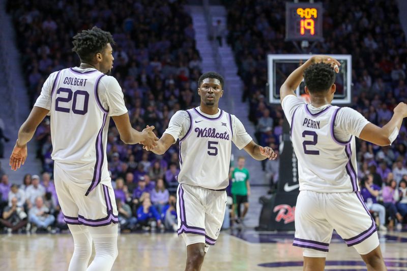 Feb 5, 2024; Manhattan, Kansas, USA; Kansas State Wildcats guard Cam Carter (5) is congratulated by forward Jerrell Colbert (20) and guard Tylor Perry (2) during the first half at Bramlage Coliseum. Mandatory Credit: Scott Sewell-USA TODAY Sports