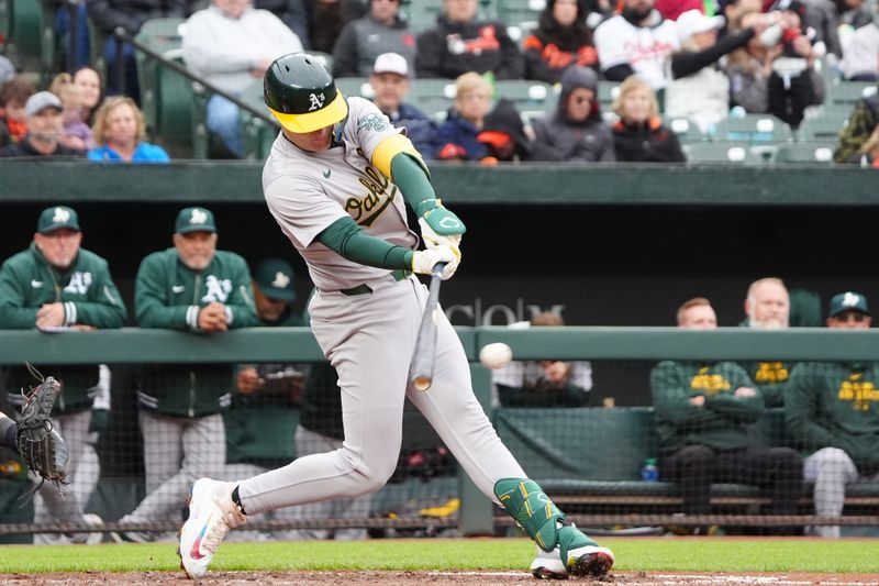 Apr 27, 2024; Baltimore, Maryland, USA; Oakland Athletics right fielder Tyler Nevin (26) hits a single against the Baltimore Orioles during the fourth inning at Oriole Park at Camden Yards. Mandatory Credit: Gregory Fisher-USA TODAY Sports