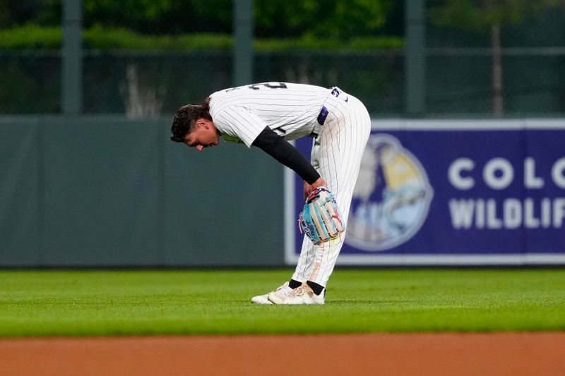 May 7, 2025; Denver, Colorado, USA; Colorado Rockies outfielder Jordan Beck (27) reacts following a fielding error during the tenth inning against the Detroit Tigers at Coors Field. Mandatory Credit: Ron Chenoy-Imagn Images
