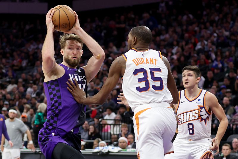 SACRAMENTO, CALIFORNIA - DECEMBER 22: Domantas Sabonis #10 of the Sacramento Kings is guarded by Kevin Durant #35 of the Phoenix Suns at Golden 1 Center on December 22, 2023 in Sacramento, California. NOTE TO USER: User expressly acknowledges and agrees that, by downloading and or using this photograph, User is consenting to the terms and conditions of the Getty Images License Agreement.  (Photo by Ezra Shaw/Getty Images)