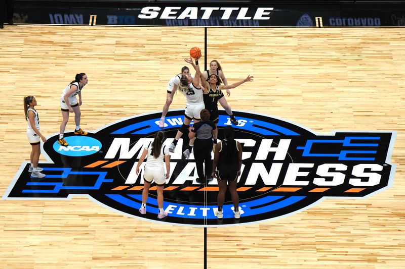 Mar 24, 2023; Seattle, WA, USA; A general overall view of the opening tipoff between Iowa Hawkeyes guard Molly Davis (1) and Colorado Buffaloes forward Brianna McLeod (25) on the March Madness logo at center court at Climate Pledge Arena. Mandatory Credit: Kirby Lee-USA TODAY Sports