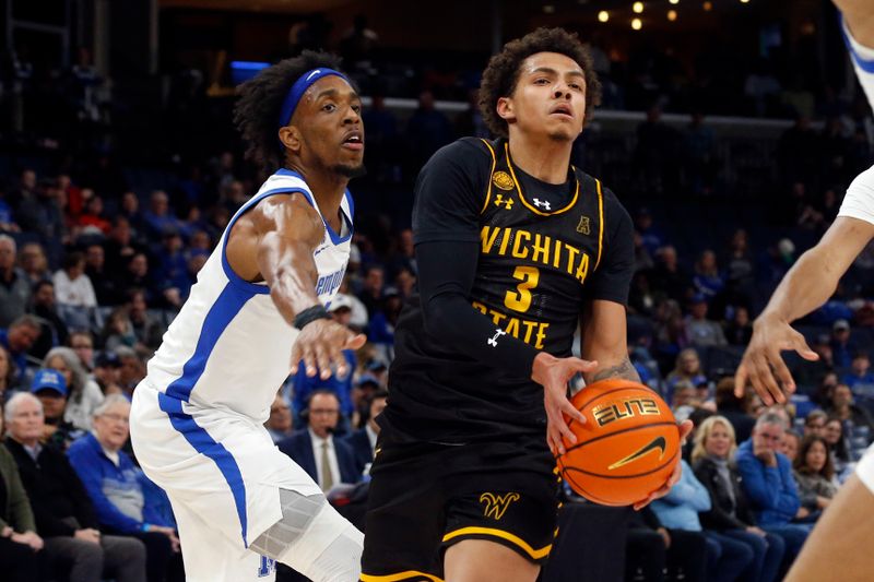 Jan 19, 2023; Memphis, Tennessee, USA; Wichita State Shockers guard Craig Porter Jr. (3) drives to the basket as Memphis Tigers forward DeAndre Williams (12) defends during the first half at FedExForum. Mandatory Credit: Petre Thomas-USA TODAY Sports