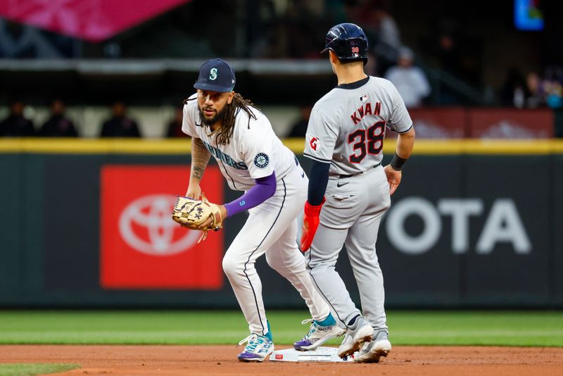 Apr 2, 2024; Seattle, Washington, USA; Seattle Mariners shortstop J.P. Crawford (3) steps on second base for a force out against Cleveland Guardians left fielder Steven Kwan (38) to end the top of the first inning at T-Mobile Park. Mandatory Credit: Joe Nicholson-USA TODAY Sports