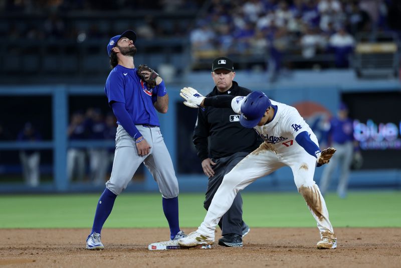 Sep 11, 2024; Los Angeles, California, USA;  Los Angeles Dodgers designated hitter Shohei Ohtani (17) steals second base ahead of a tag from Chicago Cubs shortstop Dansby Swanson (7) during the second inning at Dodger Stadium. Mandatory Credit: Kiyoshi Mio-Imagn Images