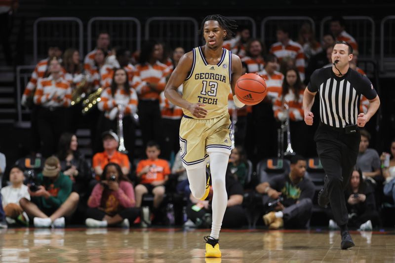 Feb 24, 2024; Coral Gables, Florida, USA; Georgia Tech Yellow Jackets guard Miles Kelly (13) dribbles the basketball against the Miami Hurricanes during the first half at Watsco Center. Mandatory Credit: Sam Navarro-USA TODAY Sports