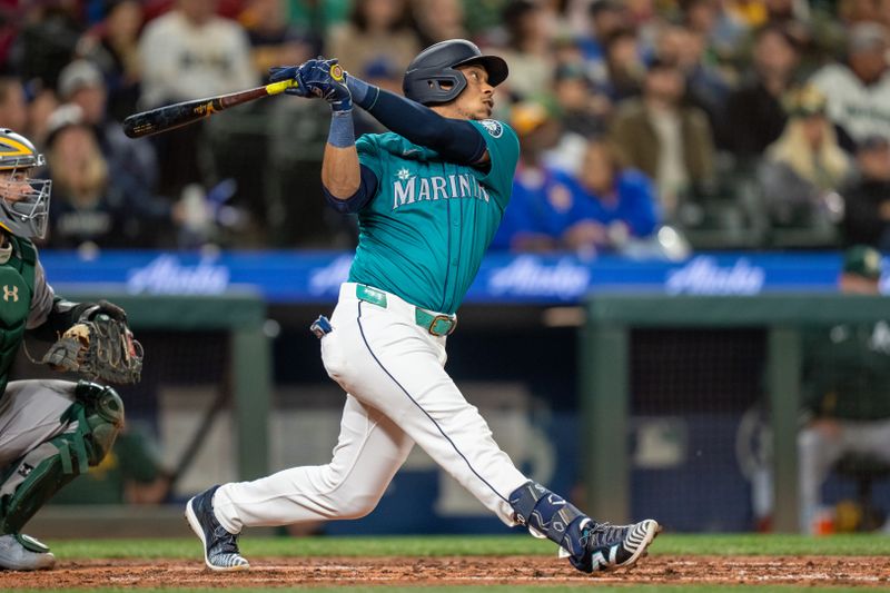 Sep 28, 2024; Seattle, Washington, USA; Seattle Mariners designated hitter Jorge Polanco (7) hits a two-run single during the fourth inning against the Oakland Athletics at T-Mobile Park. Mandatory Credit: Stephen Brashear-Imagn Images