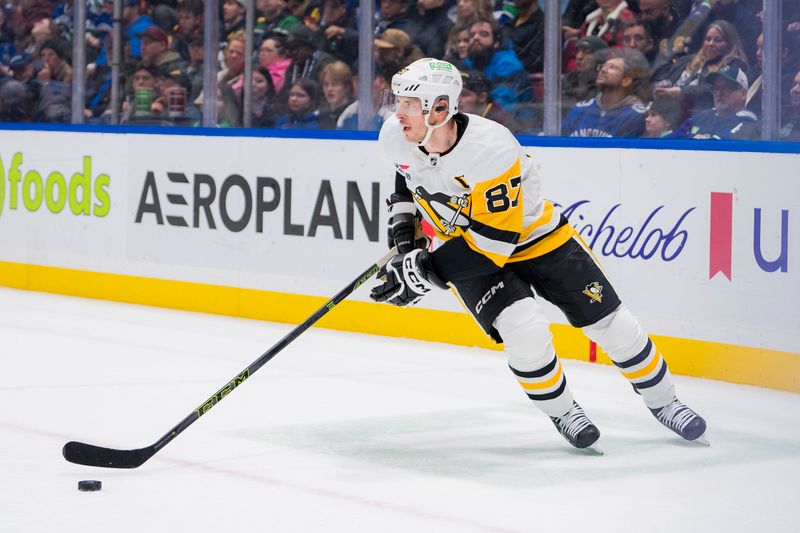 Feb 27, 2024; Vancouver, British Columbia, CAN; Pittsburgh Penguins forward Sidney Crosby (87) handles the puck against the Vancouver Canucks in the third period at Rogers Arena. Penguins won 4-3 in overtime. Mandatory Credit: Bob Frid-USA TODAY Sports