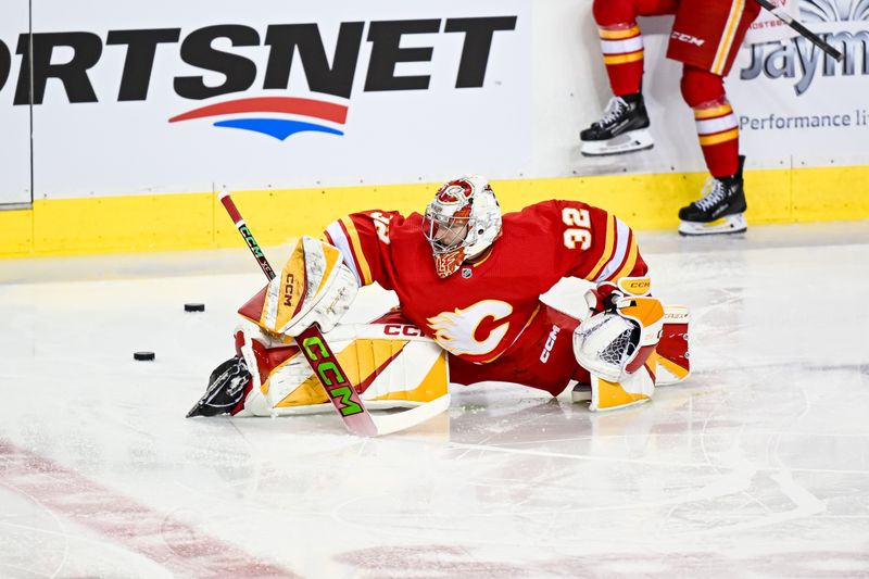 Feb 15, 2024; Calgary, Alberta, CAN; Calgary Flames goaltender Dustin Wolf (32) warms up before a game against the San Jose Sharks at Scotiabank Saddledome. Mandatory Credit: Brett Holmes-USA TODAY Sports