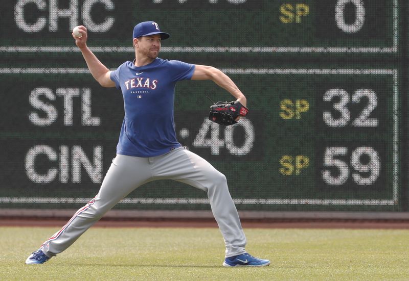 May 24, 2023; Pittsburgh, Pennsylvania, USA; Texas Rangers pitcher Jacob deGrom (48) throws in the outfield before the game against the Pittsburgh Pirates at PNC Park. Mandatory Credit: Charles LeClaire-USA TODAY Sports