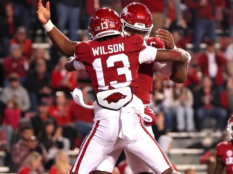 Nov 18, 2023; Fayetteville, Arkansas, USA; Arkansas Razorbacks wide receiver Jaedon Wilson (13) celebrates with quarterback KJ Jefferson (1) after scoring a touchdown in the first quarter against the FIU Panthers at Donald W. Reynolds Razorback Stadium. Mandatory Credit: Nelson Chenault-USA TODAY Sports