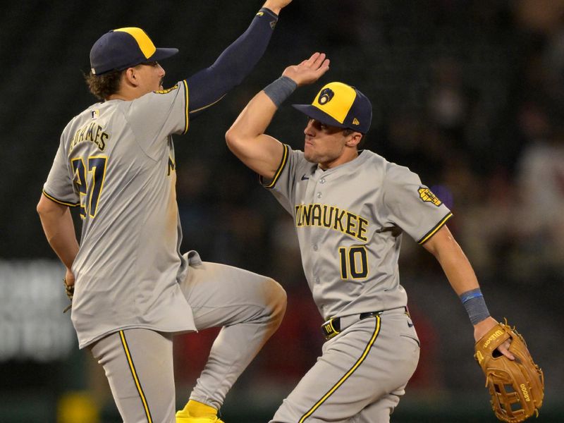 Jun 19, 2024; Anaheim, California, USA; Milwaukee Brewers shortstop Willy Adames (27) and right fielder Sal Frelick (10) celebrate after the final out of the ninth inning defeating the Los Angeles Angels at Angel Stadium. Mandatory Credit: Jayne Kamin-Oncea-USA TODAY Sports