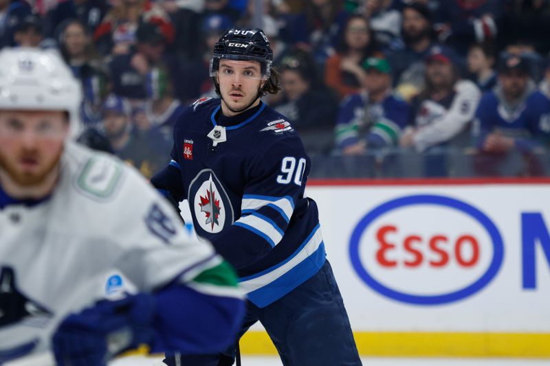 Apr 18, 2024; Winnipeg, Manitoba, CAN;  Winnipeg Jets forward Nikita Chibrikov (90) looks for the puck against the Vancouver Canucks during the first period at Canada Life Centre. Mandatory Credit: Terrence Lee-USA TODAY Sports