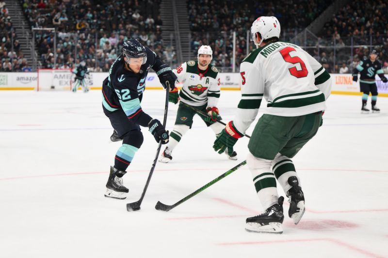 Mar 4, 2025; Seattle, Washington, USA; Seattle Kraken defenseman Brandon Montour (62) shoots the puck against the Minnesota Wild during the third period at Climate Pledge Arena. Mandatory Credit: Steven Bisig-Imagn Images