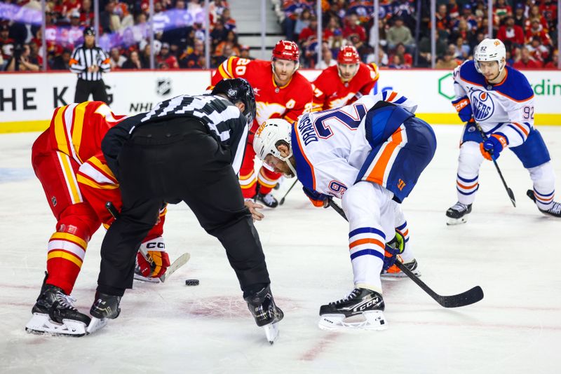 Nov 3, 2024; Calgary, Alberta, CAN; Edmonton Oilers center Leon Draisaitl (29) and Calgary Flames center Mikael Backlund (11) face off for the puck during the third period at Scotiabank Saddledome. Mandatory Credit: Sergei Belski-Imagn Images