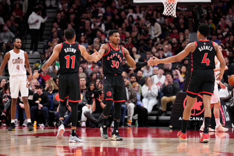 TORONTO, ON - FEBRUARY 10: Ochai Agbaji #30 of the Toronto Raptors celebrates with Bruce Brown #11 and Scottie Barnes #4 against the Cleveland Cavaliers during the first half of their basketball game at the Scotiabank Arena on February 10, 2024 in Toronto, Ontario, Canada. NOTE TO USER: User expressly acknowledges and agrees that, by downloading and/or using this Photograph, user is consenting to the terms and conditions of the Getty Images License Agreement. (Photo by Mark Blinch/Getty Images)