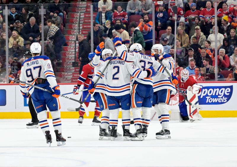 Jan 13, 2024; Montreal, Quebec, CAN; Edmonton Oilers defenseman Evan Bouchard (2) celebrates with teammates after scoring the winning goal against the Montreal Canadiens during the overtime period at the Bell Centre. Mandatory Credit: Eric Bolte-USA TODAY Sports