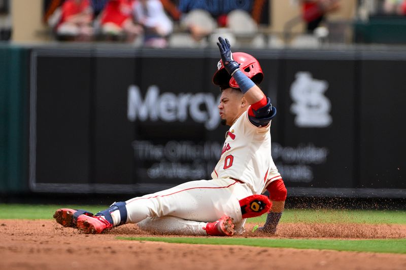 Apr 26, 2025; St. Louis, Missouri, USA;  St. Louis Cardinals shortstop Masyn Winn (0) slides in at second base for a double against the Milwaukee Brewers during the third inning at Busch Stadium. Mandatory Credit: Jeff Curry-Imagn Images