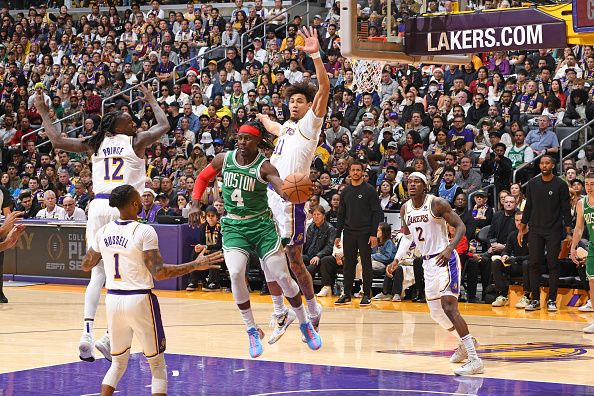 LOS ANGELES, CA - DECEMBER 25: Jrue Holiday #4 of the Boston Celtics passes the ball during the game against the Los Angeles Lakers on December 25, 2023 at Crypto.Com Arena in Los Angeles, California. NOTE TO USER: User expressly acknowledges and agrees that, by downloading and/or using this Photograph, user is consenting to the terms and conditions of the Getty Images License Agreement. Mandatory Copyright Notice: Copyright 2023 NBAE (Photo by Andrew D. Bernstein/NBAE via Getty Images)