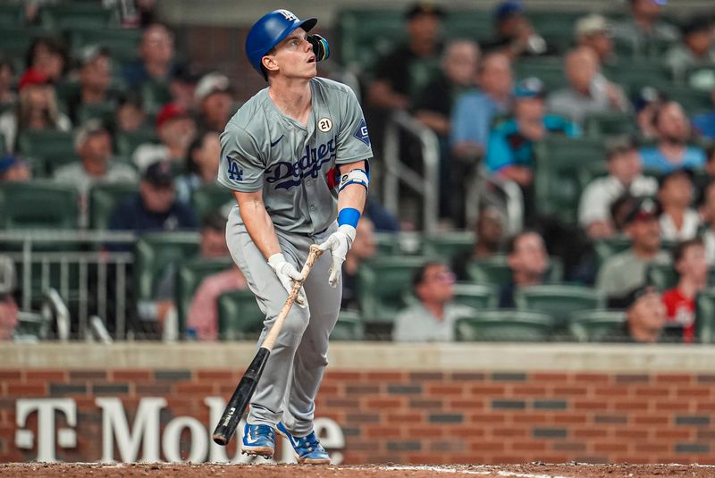 Sep 15, 2024; Cumberland, Georgia, USA; Los Angeles Dodgers catcher Will Smith (16) watches a ball he hit off of the top of the right field wall for a triple against the Atlanta Braves during the ninth inning at Truist Park. Mandatory Credit: Dale Zanine-Imagn Images