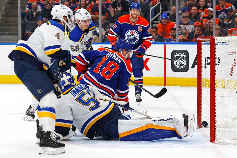 Feb 28, 2024; Edmonton, Alberta, CAN; Edmonton Oilers forward Zach Hyman (18) scores a goal during the first period against St. Louis Blues goaltender Jordan Binnington (50) at Rogers Place. Mandatory Credit: Perry Nelson-USA TODAY Sports