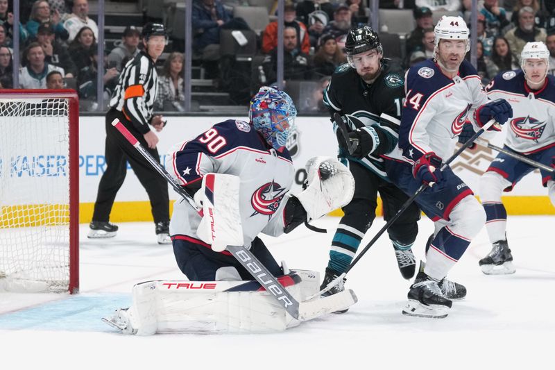 Feb 17, 2024; San Jose, California, USA; Columbus Blue Jackets goaltender Elvis Merzlikins (90) makes a save against the San Jose Sharks during the second period at SAP Center at San Jose. Mandatory Credit: Darren Yamashita-USA TODAY Sports