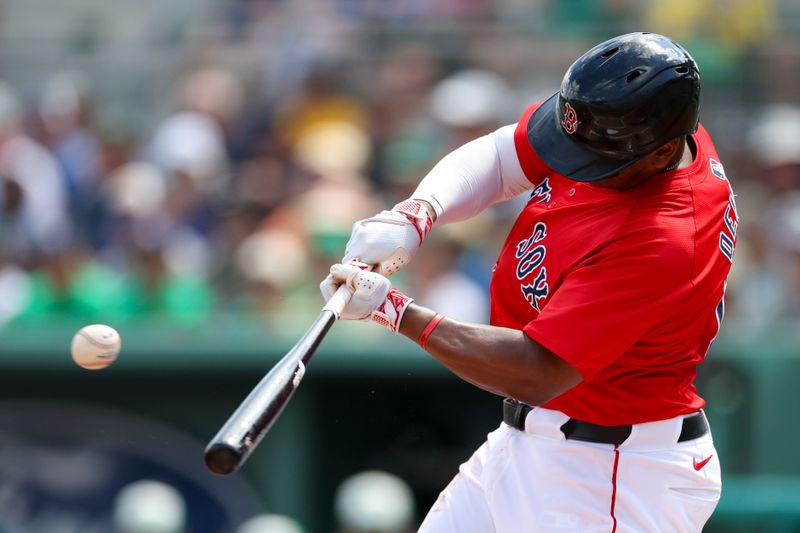 Mar 17, 2024; Fort Myers, Florida, USA;  Boston Red Sox third baseman Rafael Devers (11) singles against the New York Yankees in the first inning at JetBlue Park at Fenway South. Mandatory Credit: Nathan Ray Seebeck-USA TODAY Sports