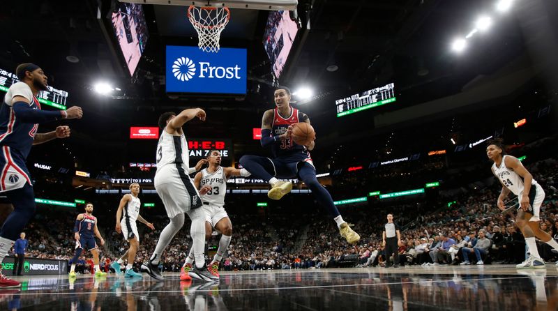 SAN ANTONIO, TX - JANUARY  29:   Kyle Kuzma #33 of the Washington Wizards drives on Keldon Johnson #3 of the San Antonio Spurs in the second half at Frost Bank Center on January 29, 2024 in San Antonio, Texas. NOTE TO USER: User expressly acknowledges and agrees that, by downloading and or using this photograph, User is consenting to terms and conditions of the Getty Images License Agreement. (Photo by Ronald Cortes/Getty Images)