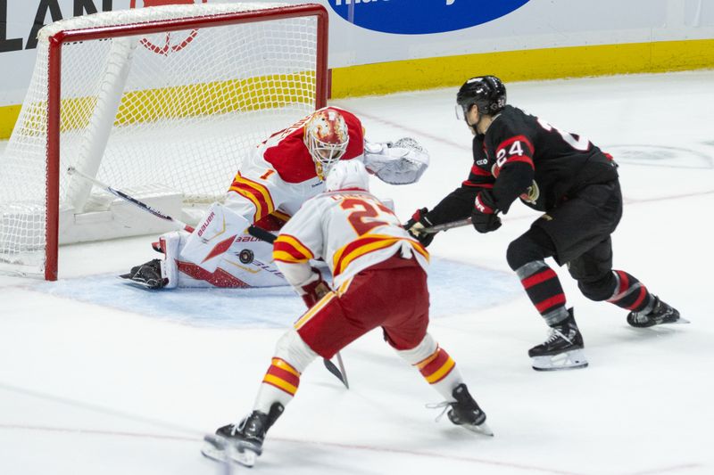 Oct 30, 2025; Ottawa, Ontario, CAN; Calgary Flames goalie Devin Cooley (1) makes a save on a shot from Ottawa Senators center Dylan Cozens (24) in the third period at the Canadian Tire Centre. Mandatory Credit: Marc DesRosiers-IMAGN Images