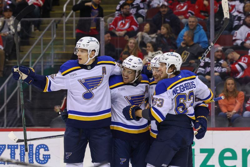 Nov 27, 2024; Newark, New Jersey, USA; St. Louis Blues center Dylan Holloway (81) celebrates his goal against the New Jersey Devils during the first period at Prudential Center. Mandatory Credit: Ed Mulholland-Imagn Images