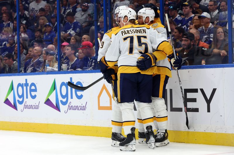 Oct 10, 2023; Tampa, Florida, USA; Nashville Predators center Ryan O'Reilly (90) is congratulated after he scored against the Tampa Bay Lightning during the second period at Amalie Arena. Mandatory Credit: Kim Klement Neitzel-USA TODAY Sports