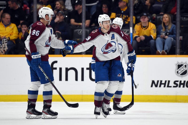 Mar 2, 2024; Nashville, Tennessee, USA; Colorado Avalanche center Nathan MacKinnon (29) is congratulated by right wing Mikko Rantanen (96) after a goal during the first period against the Nashville Predators at Bridgestone Arena. Mandatory Credit: Christopher Hanewinckel-USA TODAY Sports