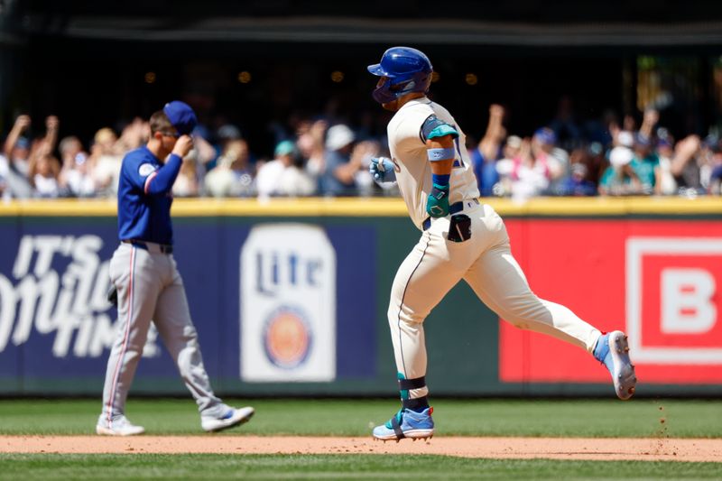 Jun 16, 2024; Seattle, Washington, USA; Seattle Mariners first baseman Tyler Locklear (27) runs the bases after hitting a solo-home run against the Texas Rangers during the seventh inning at T-Mobile Park. Mandatory Credit: Joe Nicholson-USA TODAY Sports