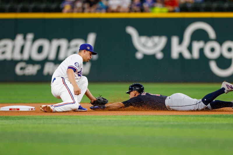 May 13, 2024; Arlington, Texas, USA;  Cleveland Guardians second base Andrés Giménez (0) is tagged out by Texas Rangers shortstop Corey Seager (5) trying to steal second base during the first inning at Globe Life Field. Mandatory Credit: Andrew Dieb-USA TODAY Sports