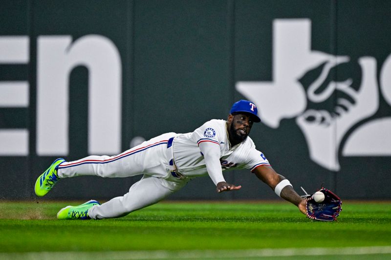 Sep 5, 2024; Arlington, Texas, USA; Texas Rangers right fielder Adolis Garcia (53) leaps but cannot catch a fly ball hit by Los Angeles Angels designated hitter Brandon Drury (not pictured) during the seventh inning at Globe Life Field. Mandatory Credit: Jerome Miron-Imagn Images