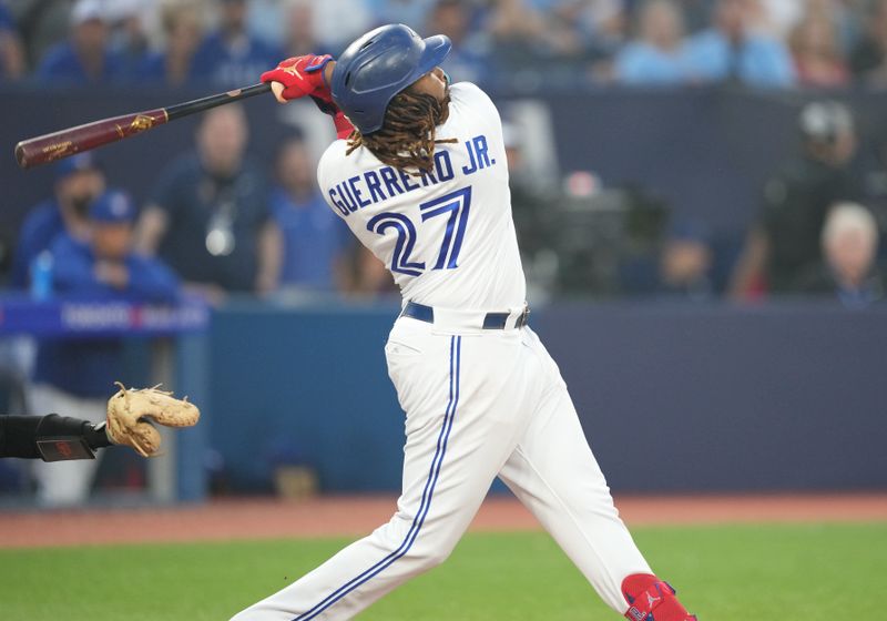 Jun 29, 2023; Toronto, Ontario, CAN; Toronto Blue Jays designated hitter Vladimir Guerrero Jr. (27) hits a two run home run against the San Francisco Giants during the sixth inning at Rogers Centre. Mandatory Credit: Nick Turchiaro-USA TODAY Sports