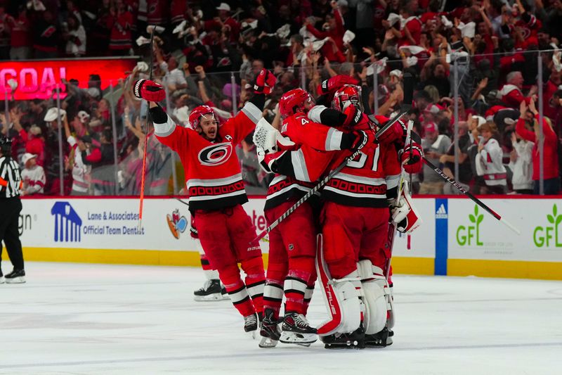 May 11, 2023; Raleigh, North Carolina, USA; Carolina Hurricanes goaltender Frederik Andersen (31), defenseman Jaccob Slavin (74), center Derek Stepan (21), left wing Jordan Martinook (48) and center Sebastian Aho (20) celebrate their victory in overtime against the New Jersey Devils in game five of the second round of the 2023 Stanley Cup Playoffs at PNC Arena. Mandatory Credit: James Guillory-USA TODAY Sports