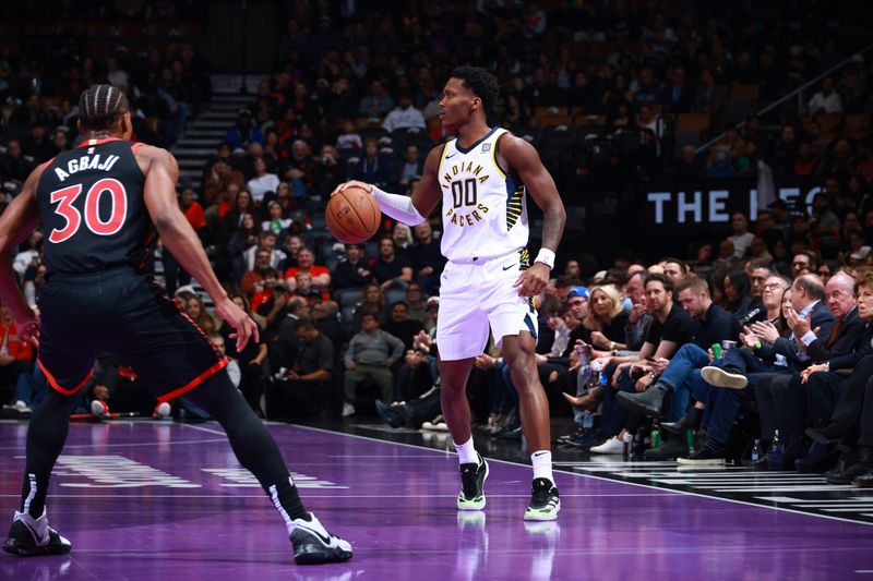 TORONTO, CANADA - DECEMBER 3: Bennedict Mathurin #00 of the Indiana Pacers handles the ball during the game against the Toronto Raptors during the Emirates NBA Cup game on December 3, 2024 at the Scotiabank Arena in Toronto, Ontario, Canada.  NOTE TO USER: User expressly acknowledges and agrees that, by downloading and or using this Photograph, user is consenting to the terms and conditions of the Getty Images License Agreement.  Mandatory Copyright Notice: Copyright 2024 NBAE (Photo by Vaughn Ridley/NBAE via Getty Images)