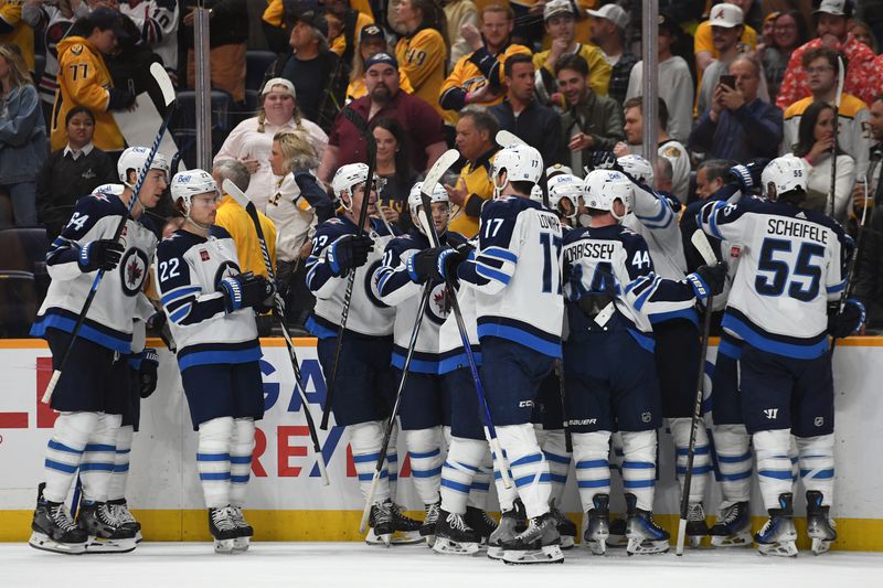 Apr 9, 2024; Nashville, Tennessee, USA; Winnipeg Jets players celebrate after a game-winning goal by left wing Kyle Connor (81) in overtime to beat the Nashville Predators at Bridgestone Arena. Mandatory Credit: Christopher Hanewinckel-USA TODAY Sports